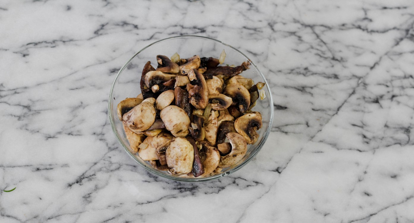 overhead image of mushrooms in a glass dish.