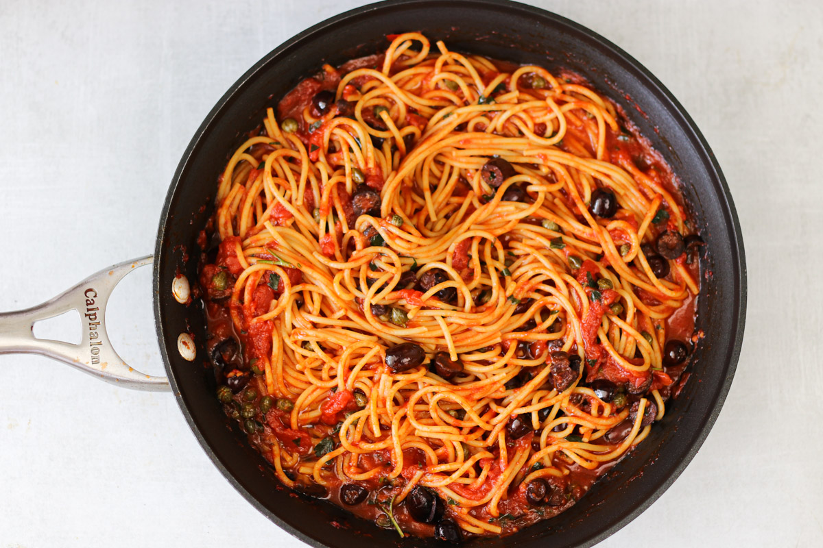 overhead image of easy pasta puttanesca in a large skillet