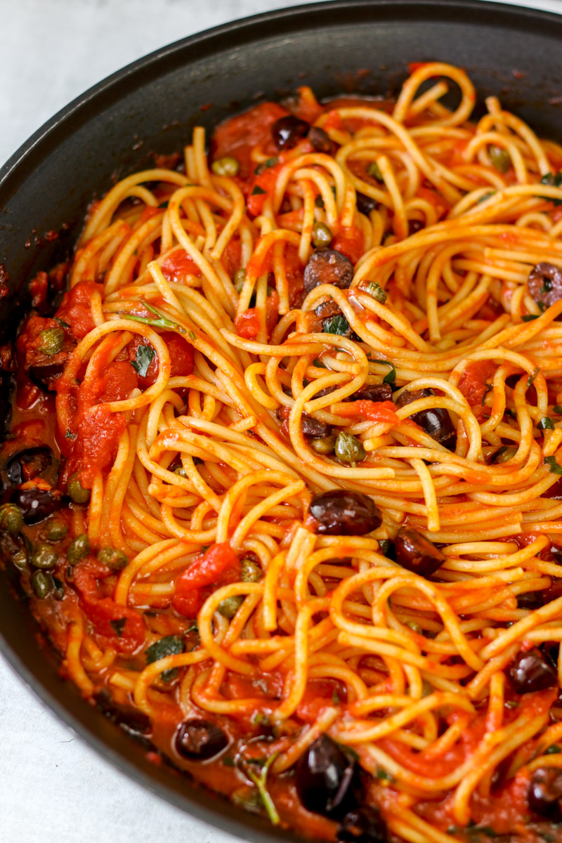 close up image of authentic Italian puttanesca pasta.