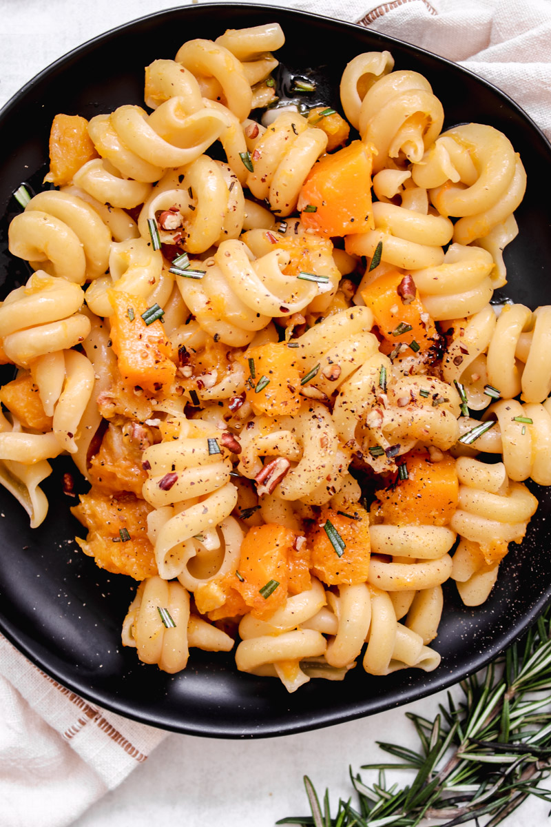 overhead image of pasta on a black plate