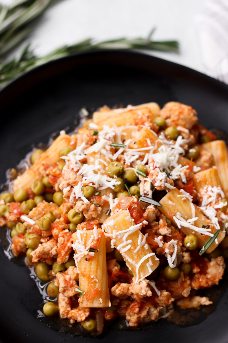 overhead image of pasta on a black plate