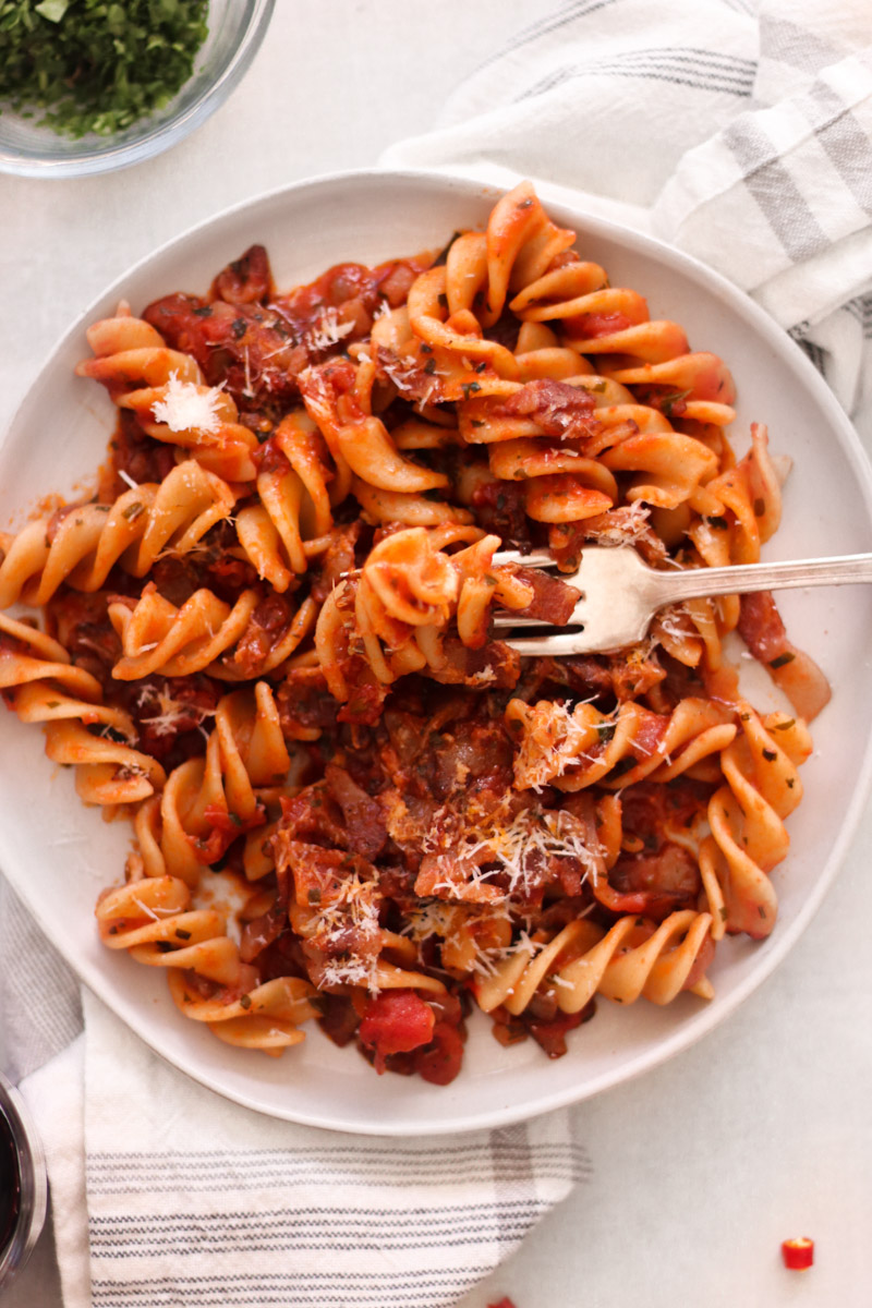 pasta amatriciana overhead shot on white plate.