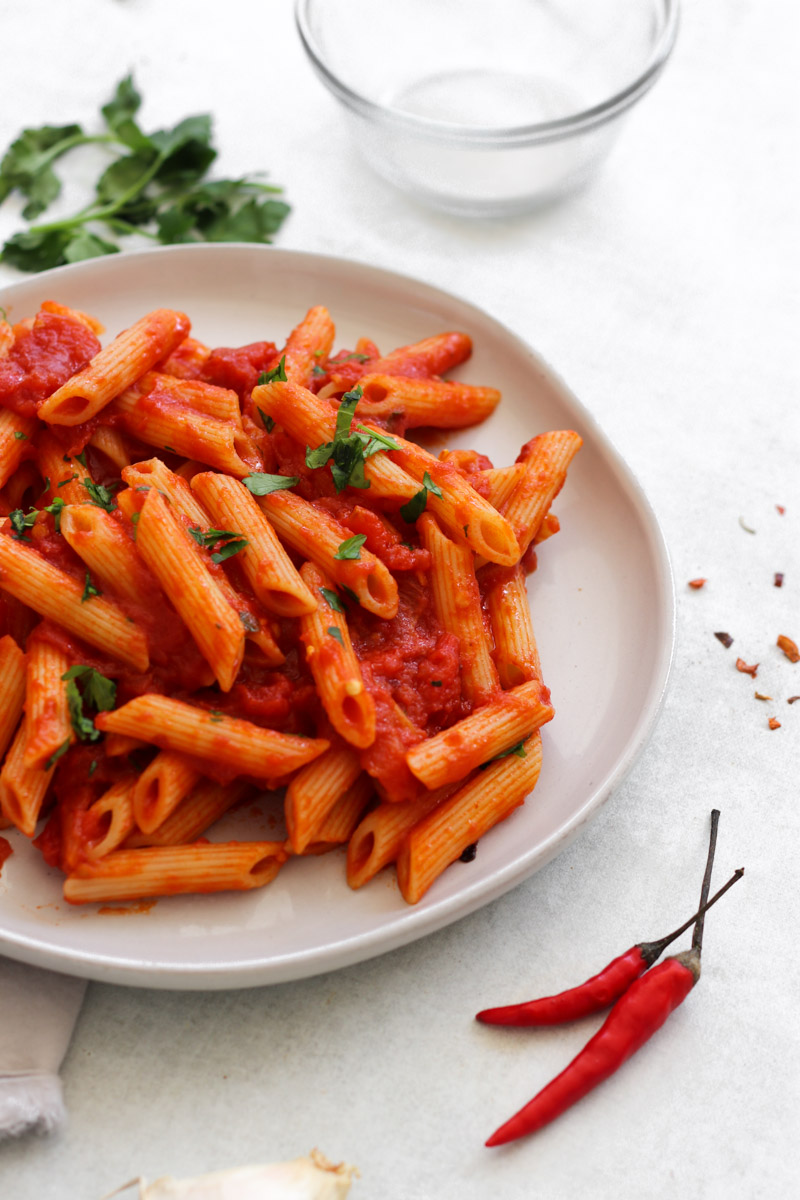 Close up of penne all’arrabbiata with red pepper flakes