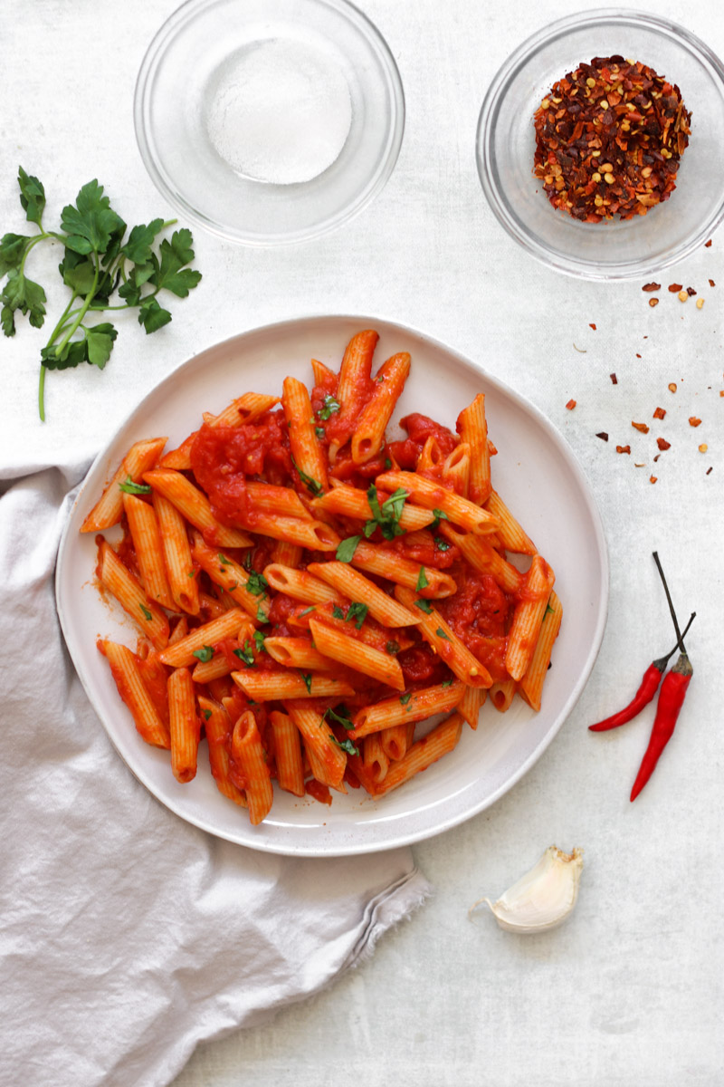 Close up of penne all’arrabbiata with red pepper flakes