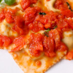 Ravioli with tomato sauce.