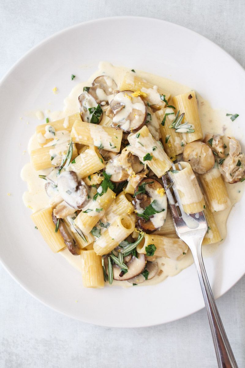 Chicken and mushroom pasta recipe on a white plate.
