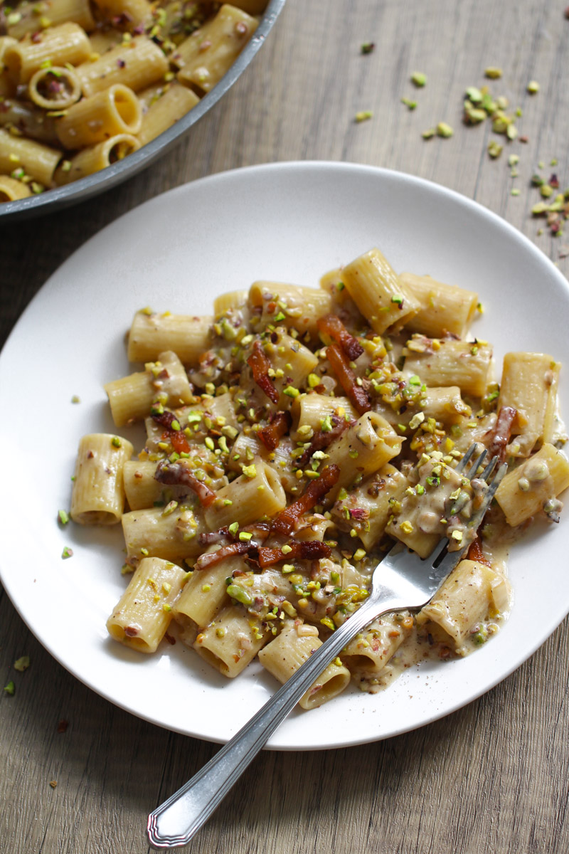 Creamy pistachio pasta on a white dish.