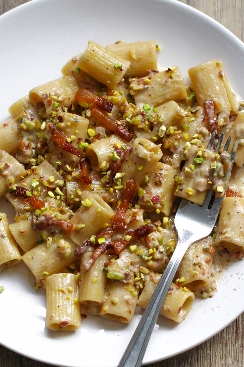Creamy pistachio pasta on a white dish.