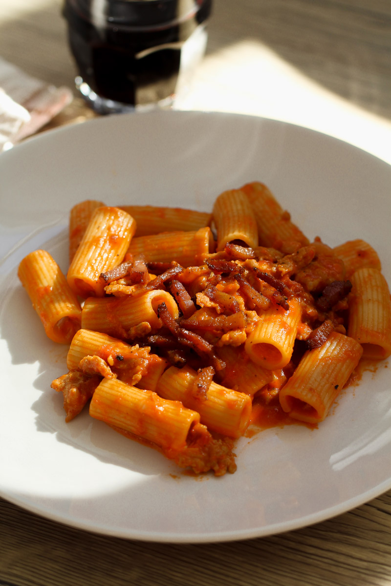 close up image of pasta alla zozzona on a white plate. 