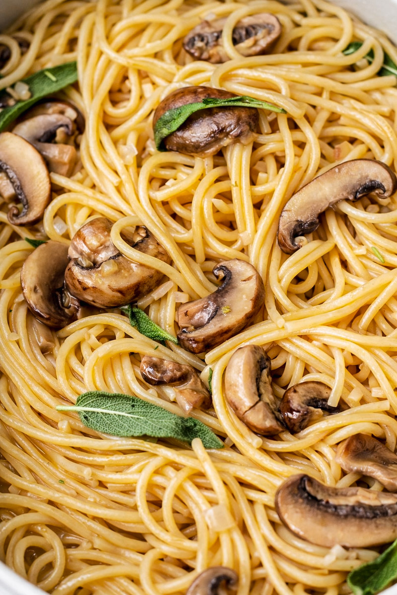 close up image of easy mushroom pasta without cream served on a white plate.